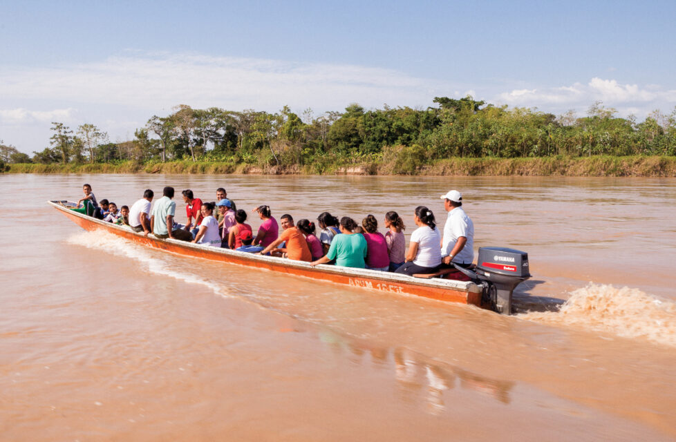 A group of people in a canoe going up the river