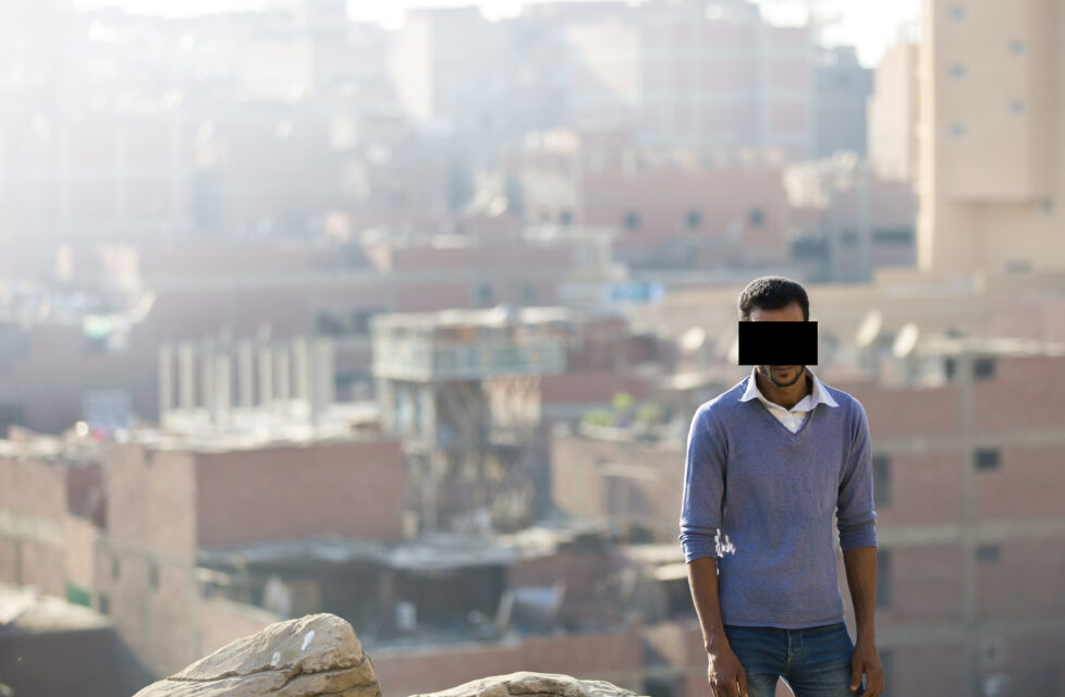 A man stands on the outside of a city