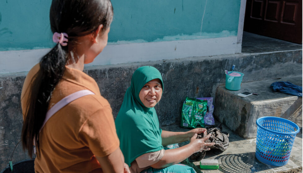 indonesian woman talks to woman in hijab