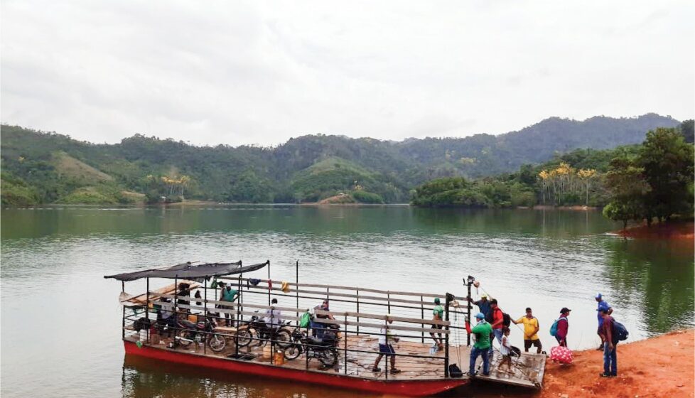 Colombian front line workers load bibles onto a boat