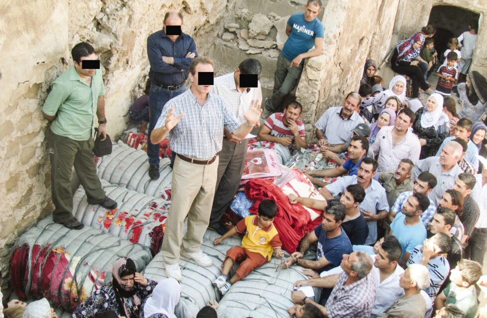 Iraq: Christians Forced to Flee During Mosul Crisis A man preaches to a large group of people outside