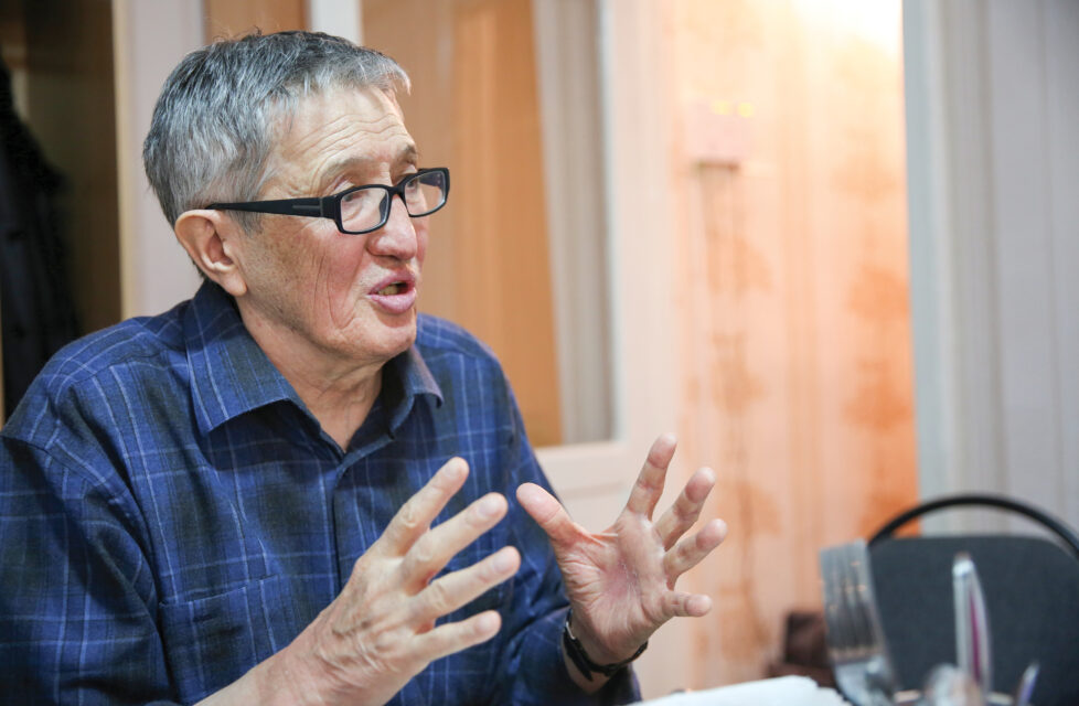 Older man sits and gives his testamony