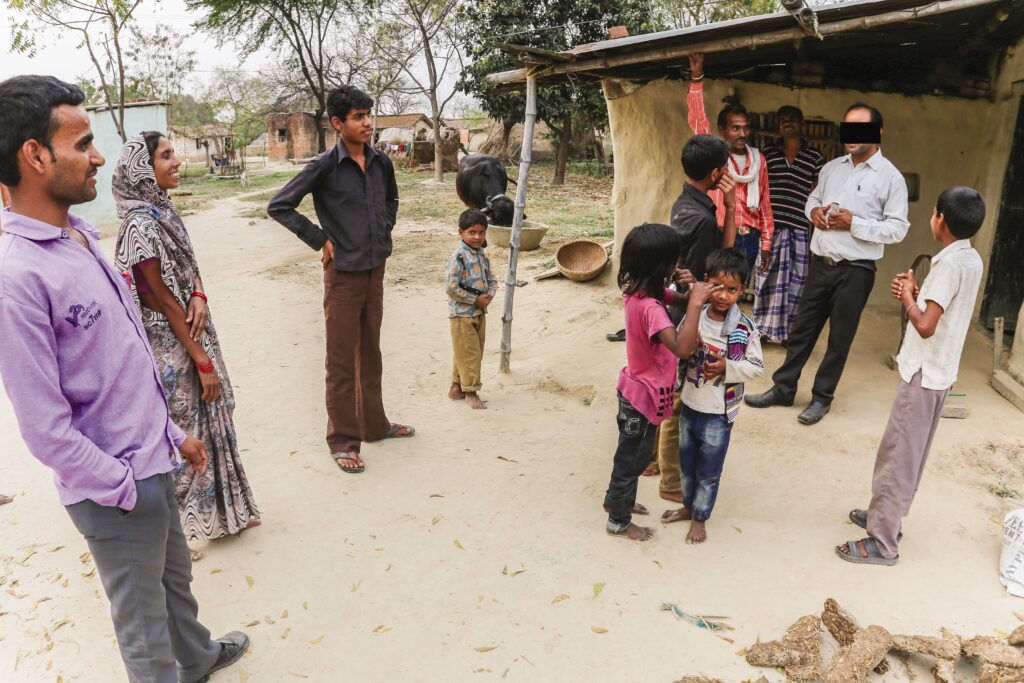 a group of people surround man while he preaches