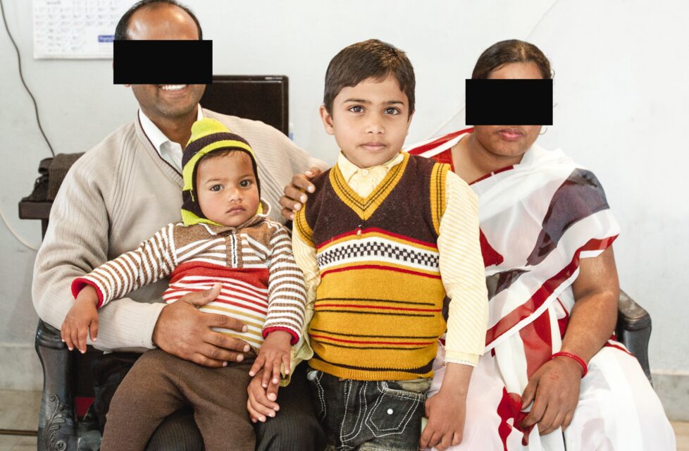 Woman Stands Up For Her Faith: “Burn Us. We Don’t Fear That” a family of 4 sits on a couch together